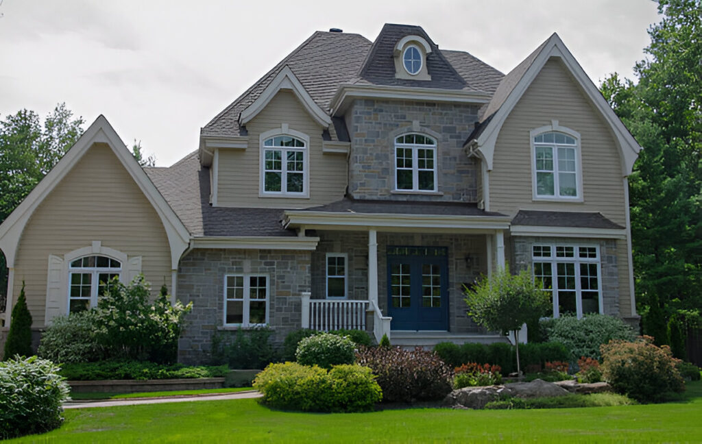 Newly completed residential construction featuring a stone facade and elegant landscaping