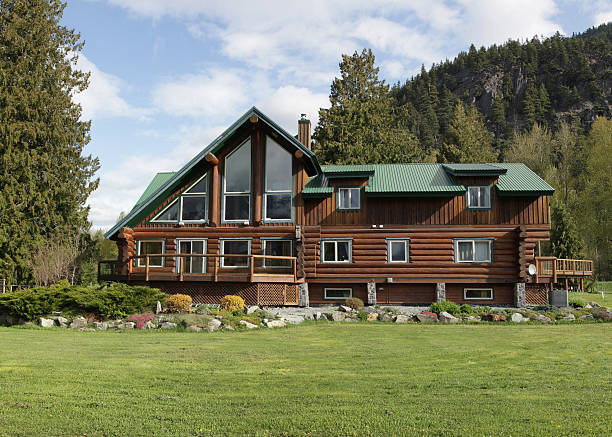 Completed log cabin with a green roof and beautiful landscaping